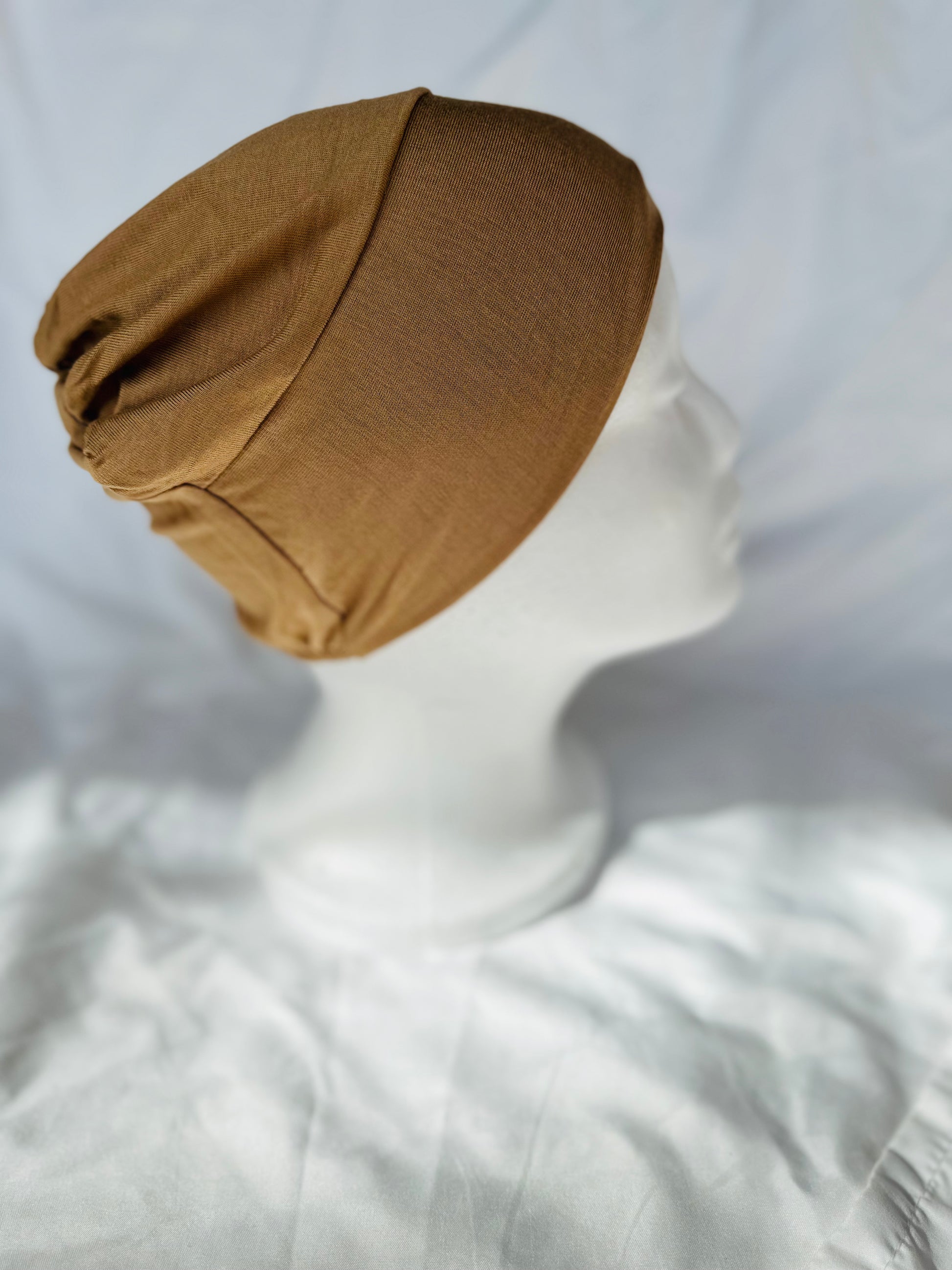 Tan hijab undercap made from breathable jersey fabric, designed by Zoya Z for secure and comfortable everyday wear.