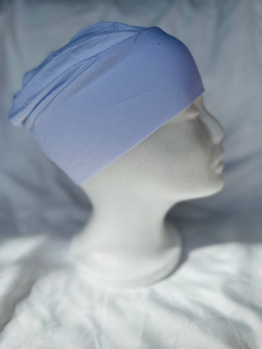 White hijab undercap made from breathable jersey fabric, designed by Zoya Z for secure and comfortable layering under hijabs.