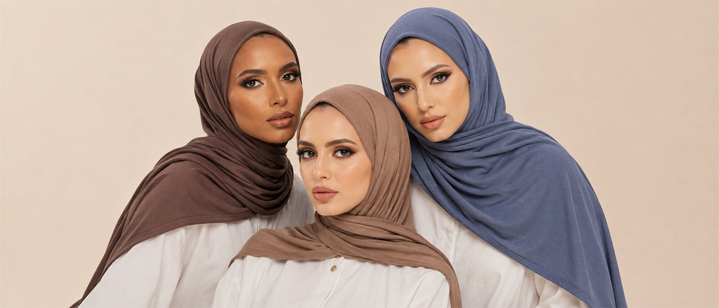 Three women wearing modal hijabs in brown, taupe, and dusty blue, styled together against a soft beige background — Zoya Z modest fashion collection