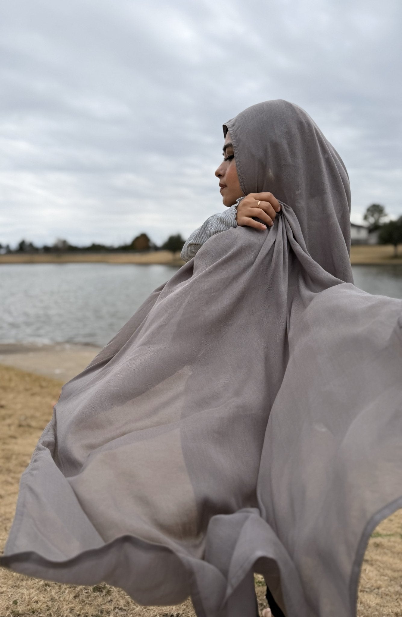 Gray modal hijab with soft, flowing drape and breathable non-slip fabric, styled outdoors for everyday modest wear