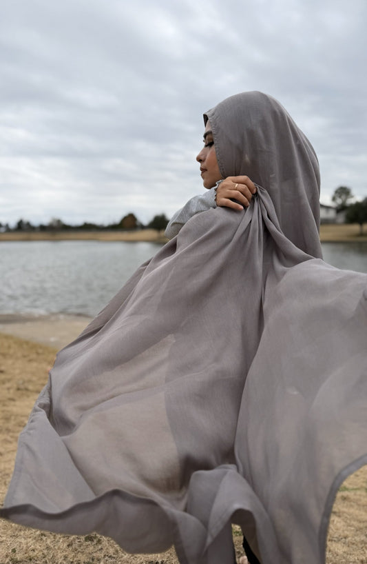 Gray modal hijab with soft, flowing drape and breathable non-slip fabric, styled outdoors for everyday modest wear