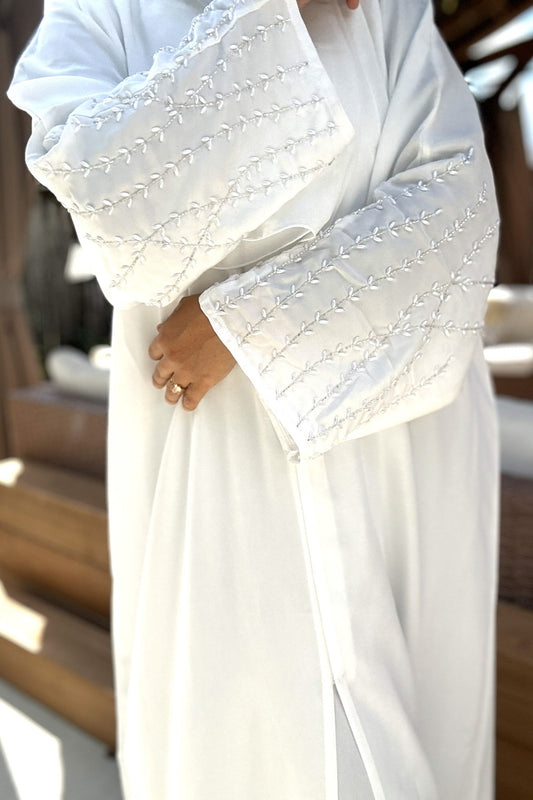 Close-up of pearl detailing on sleeves of Noor Pearl White Abaya