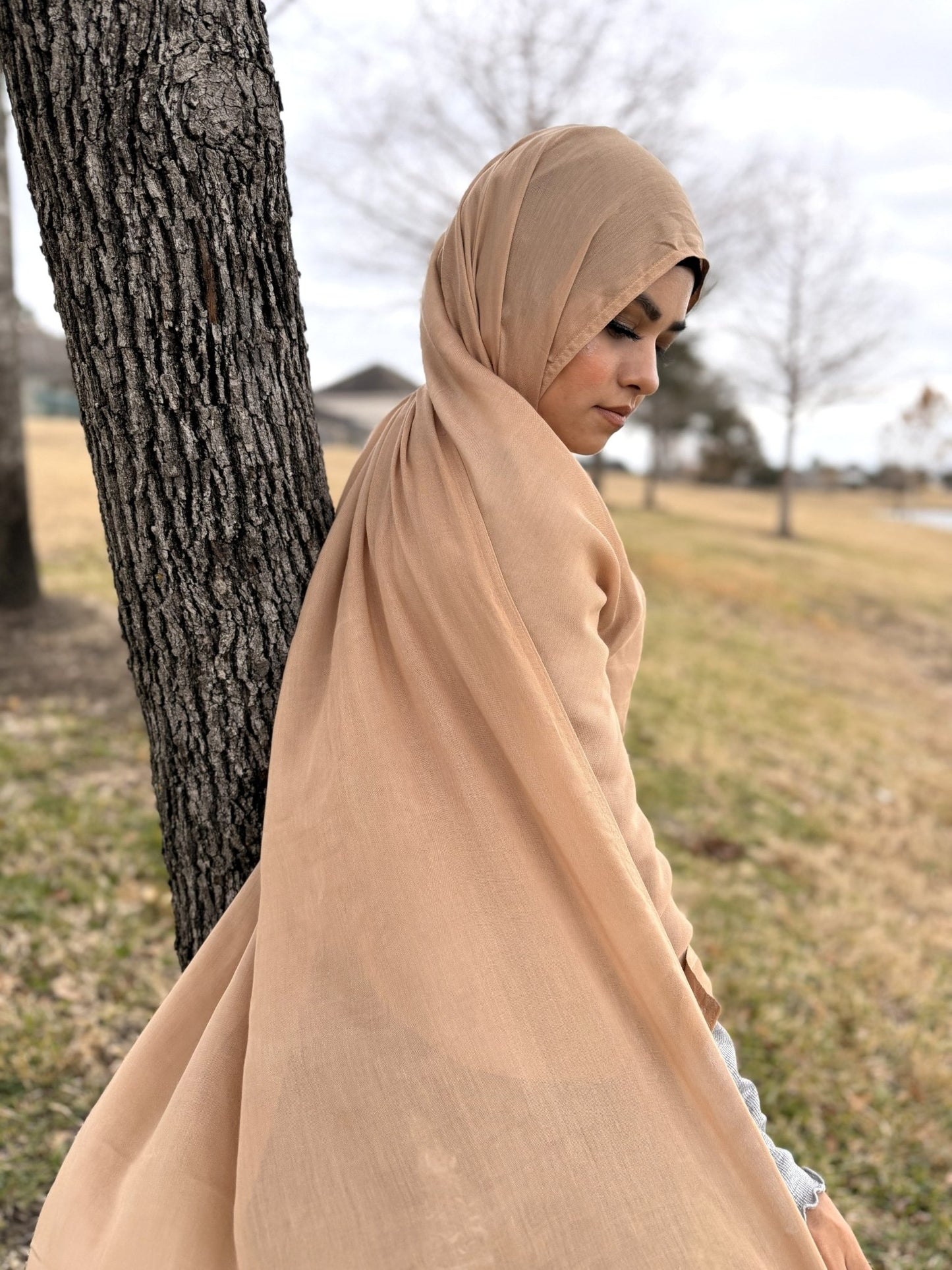 Beige modal hijab with soft drape and breathable fabric, styled outdoors for elegant everyday modest wear