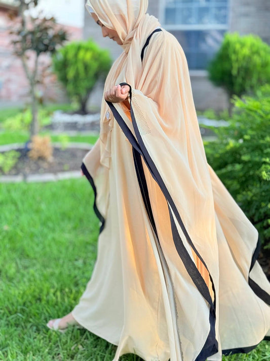 Model wearing Luxury Beige Abaya with Black Detailing in a modest and refined silhouette