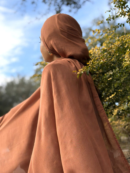 Lightweight burnt modal hijab with graceful drape and breathable fabric, styled casually outdoors for everyday use