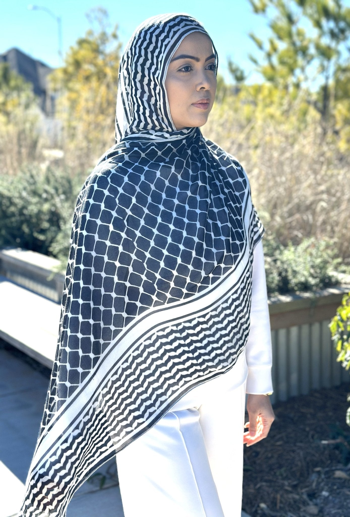 Model wearing Black Keffiyeh Hijab with classic pattern and soft flowing drape