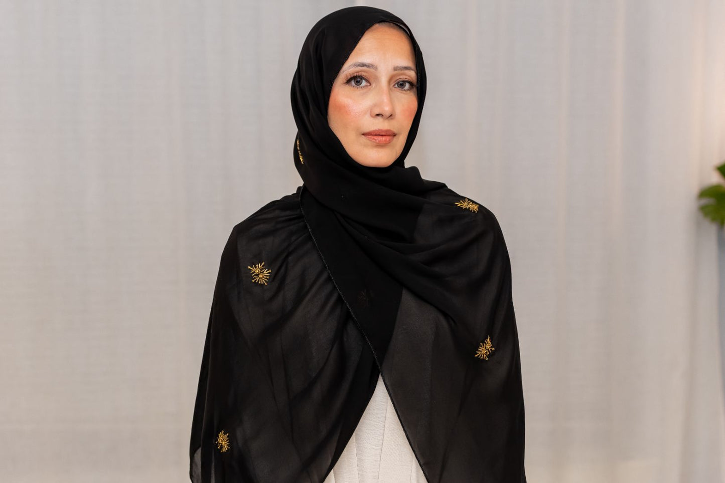 Luxury black chiffon hijab with gold bead embroidery, designed by Zoya Z for elegant modest fashion styling.