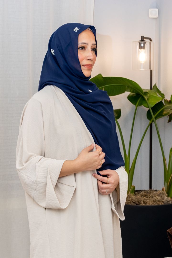 Luxury blue chiffon hijab with white pearl embellishments, designed by Zoya Z for timeless modest fashion styling.