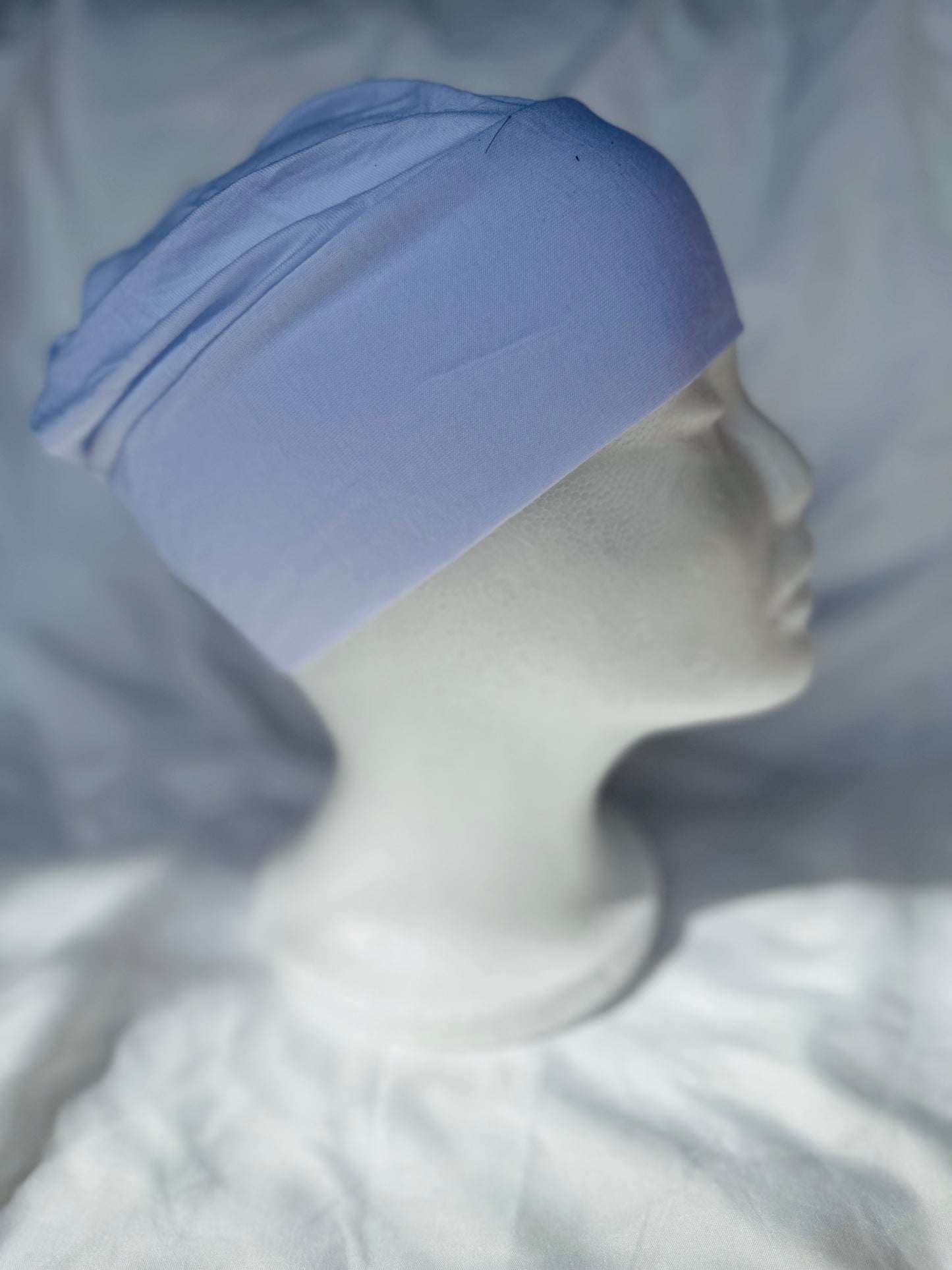 White hijab undercap made from breathable jersey fabric, designed by Zoya Z for secure and comfortable layering under hijabs.