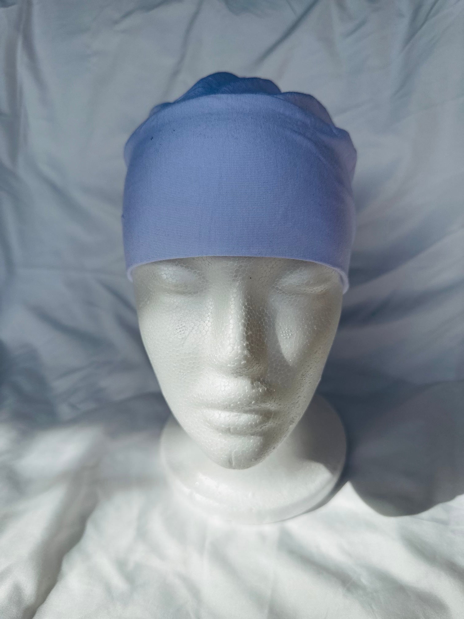 White hijab undercap made from breathable jersey fabric, designed by Zoya Z for secure and comfortable layering under hijabs.