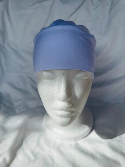 White hijab undercap made from breathable jersey fabric, designed by Zoya Z for secure and comfortable layering under hijabs.